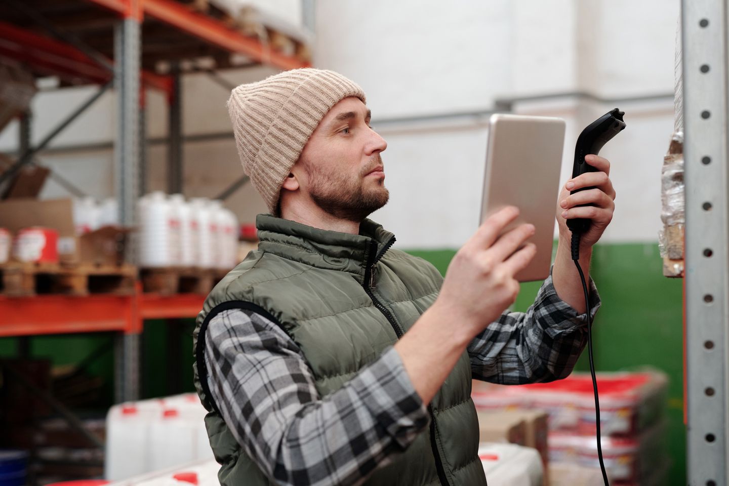Warehouse worker using a handheld scanner for inventory control.