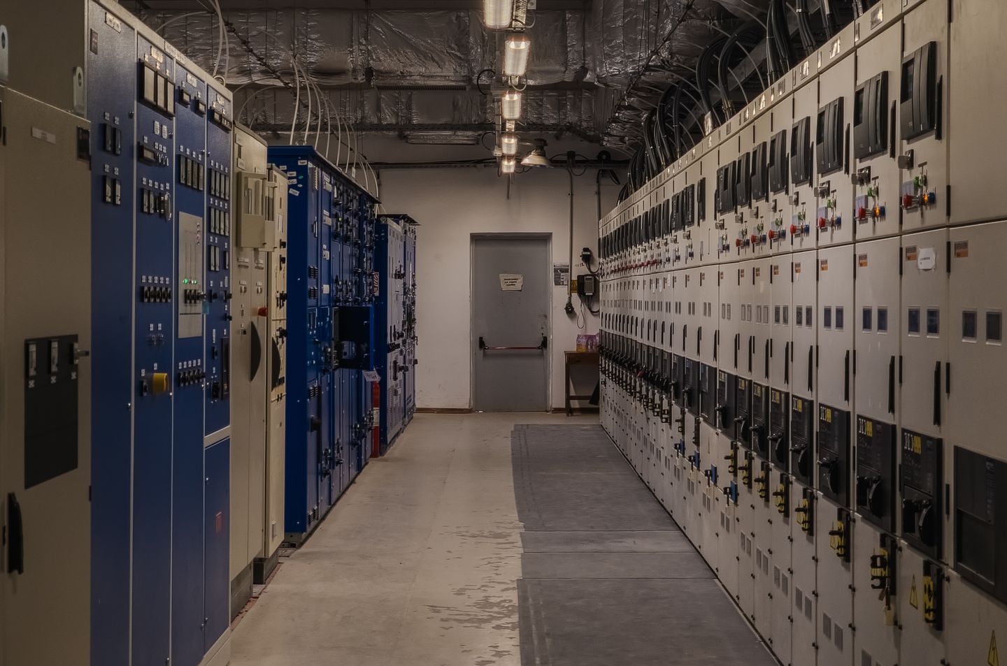 Industrial control room with electrical panels and connected equipment.